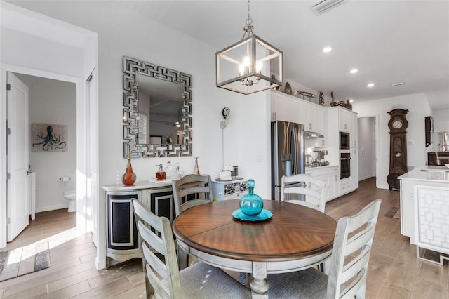 dining room featuring light hardwood / wood-style floors and an inviting chandelier