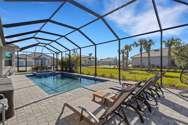 view of pool with a lanai, a lawn, and a patio