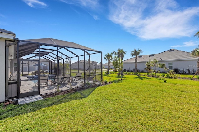 view of yard featuring a patio area and a lanai