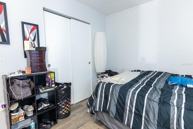 bedroom with a closet and hardwood / wood-style flooring