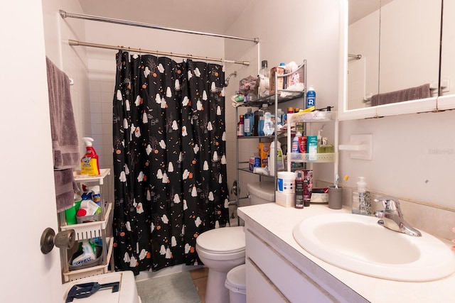 bathroom featuring tile patterned floors, vanity, toilet, and walk in shower