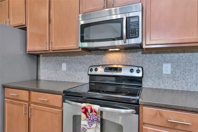 kitchen with decorative backsplash and appliances with stainless steel finishes