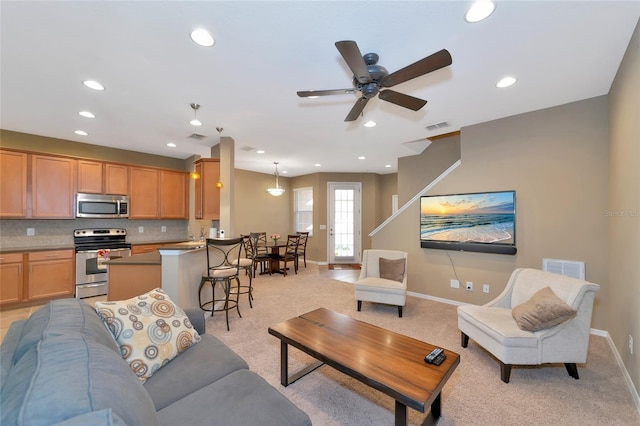 living room featuring ceiling fan and light carpet