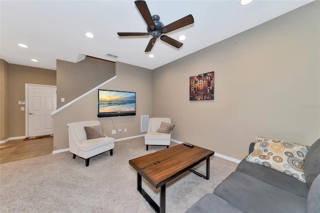 living room with ceiling fan and light colored carpet