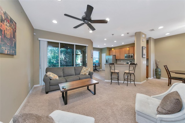 living room with light colored carpet and ceiling fan