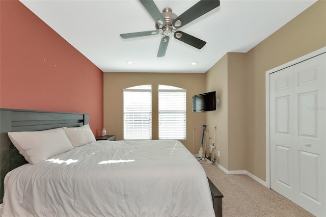 bedroom featuring ceiling fan and light carpet