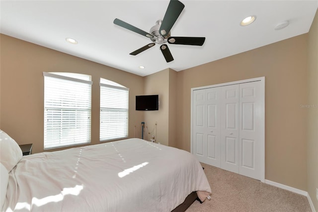 bedroom with ceiling fan, a closet, and carpet