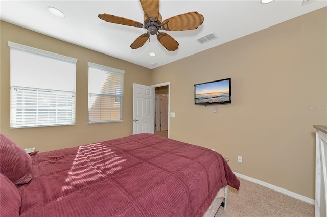 bedroom with ceiling fan and light colored carpet