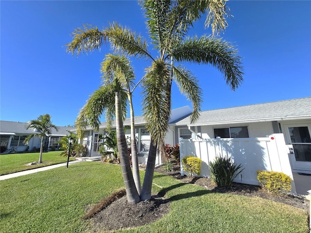 ranch-style home with a front lawn