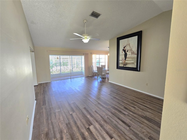 unfurnished living room with a textured ceiling, dark hardwood / wood-style flooring, ceiling fan, and lofted ceiling