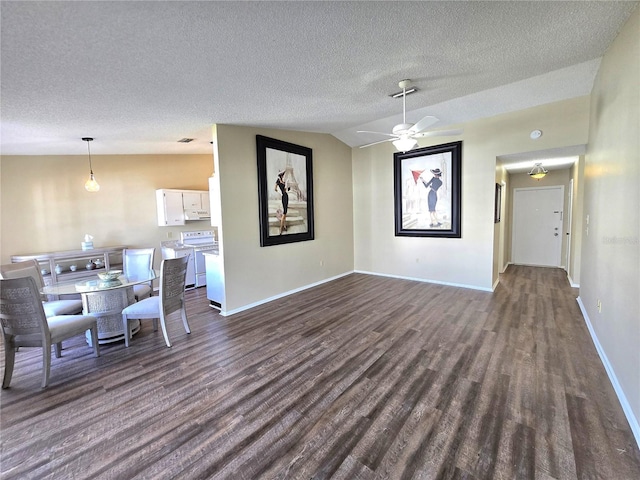 dining area with a textured ceiling, dark hardwood / wood-style flooring, vaulted ceiling, and ceiling fan