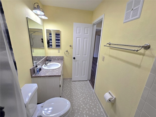 bathroom featuring vanity and toilet