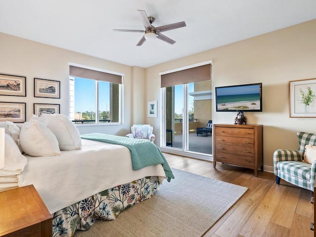 bedroom with access to exterior, ceiling fan, and light hardwood / wood-style floors