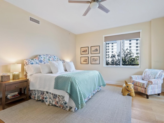 bedroom with ceiling fan and light hardwood / wood-style flooring