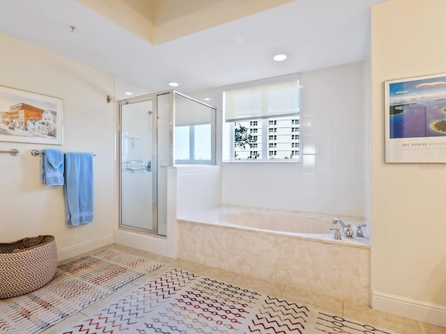 bathroom with tile patterned floors and shower with separate bathtub