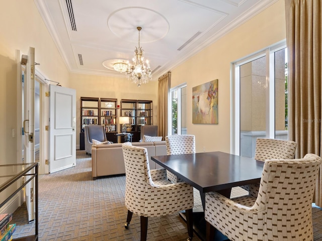 carpeted dining room featuring crown molding and a chandelier