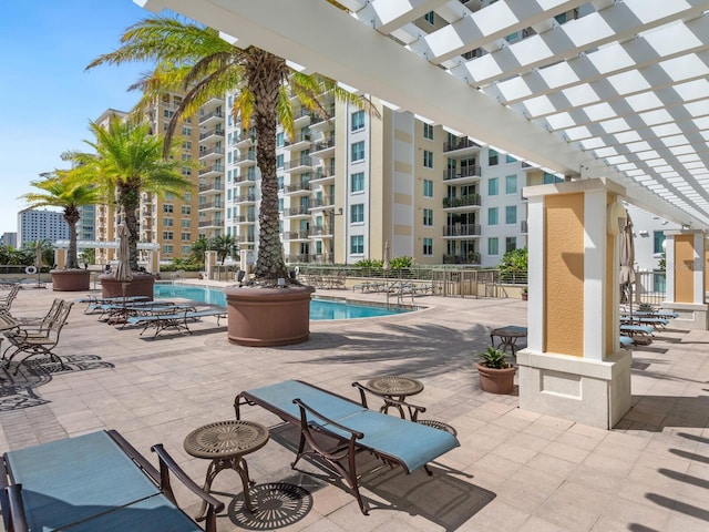 view of swimming pool featuring a patio area and a pergola