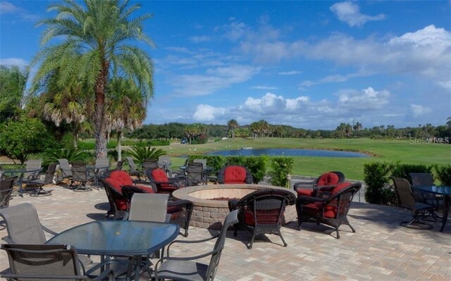 view of patio featuring a water view and a fire pit