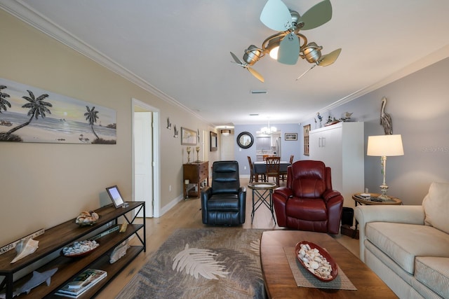 living room featuring a notable chandelier, ornamental molding, and light hardwood / wood-style flooring