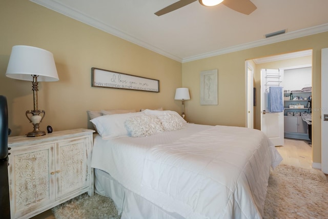 bedroom with ceiling fan, light hardwood / wood-style floors, and ornamental molding