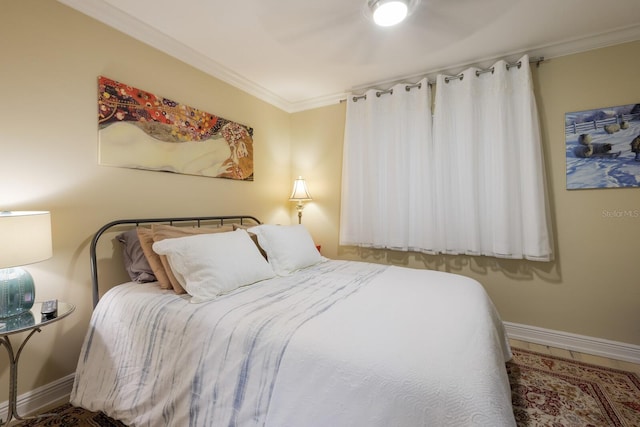 bedroom with ceiling fan and ornamental molding