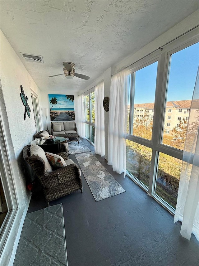 sunroom featuring ceiling fan