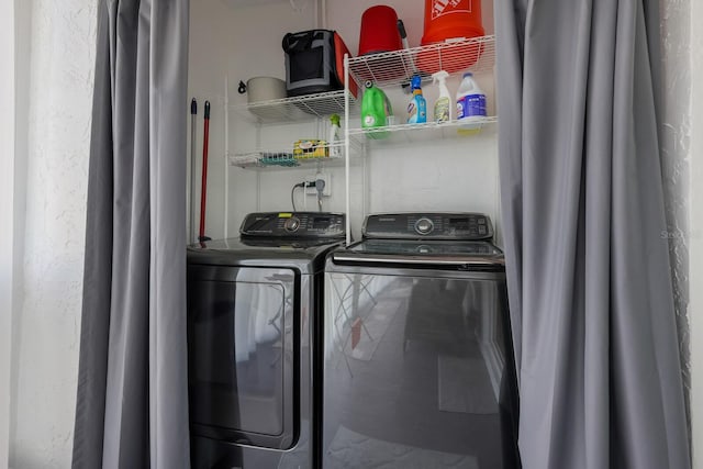 clothes washing area featuring washing machine and dryer