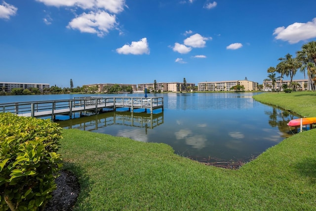 dock area featuring a water view and a yard