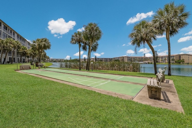 surrounding community with a yard and a water view