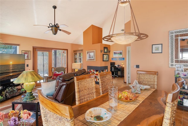 tiled dining space with high vaulted ceiling and ceiling fan