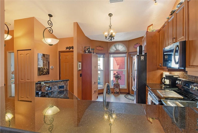 kitchen featuring backsplash, dark stone countertops, decorative light fixtures, stainless steel appliances, and a chandelier