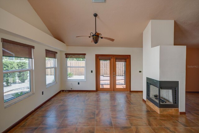 7806 Ontario Street Cir Unit 7806, Sarasota, FL 34243 - unfurnished living room featuring a ceiling fan, vaulted ceiling, dark tile patterned flooring, a multi sided fireplace, and baseboards