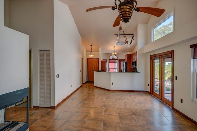 7806 Ontario Street Cir Unit 7806, Sarasota, FL 34243 - unfurnished living room with high vaulted ceiling, a ceiling fan, plenty of natural light, and baseboards
