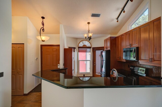 7806 Ontario Street Cir Unit 7806, Sarasota, FL 34243 - kitchen featuring stainless steel microwave, freestanding refrigerator, black electric range, lofted ceiling, and dark countertops