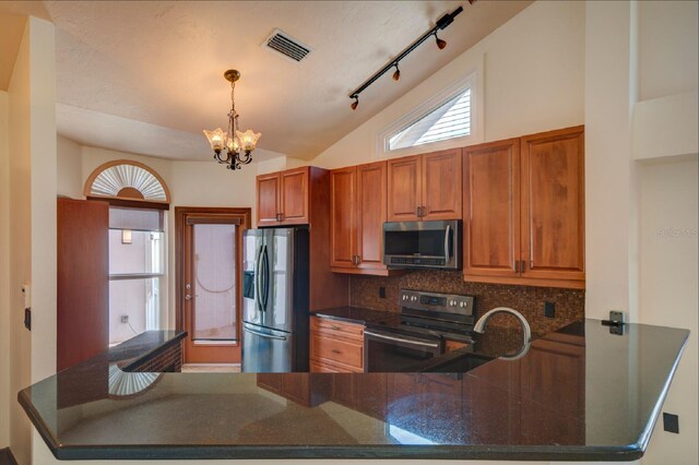 7806 Ontario Street Cir Unit 7806, Sarasota, FL 34243 - kitchen featuring stainless steel appliances, a peninsula, a chandelier, backsplash, and healthy amount of natural light