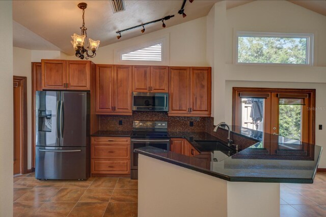 7806 Ontario Street Cir Unit 7806, Sarasota, FL 34243 - kitchen featuring appliances with stainless steel finishes, a sink, a chandelier, brown cabinets, and light tile patterned flooring