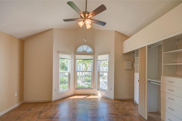 7806 Ontario Street Cir Unit 7806, Sarasota, FL 34243 - unfurnished bedroom with multiple windows, tile patterned flooring, vaulted ceiling, and baseboards