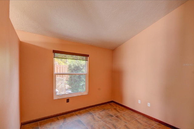 7806 Ontario Street Cir Unit 7806, Sarasota, FL 34243 - tiled spare room featuring baseboards and a textured ceiling