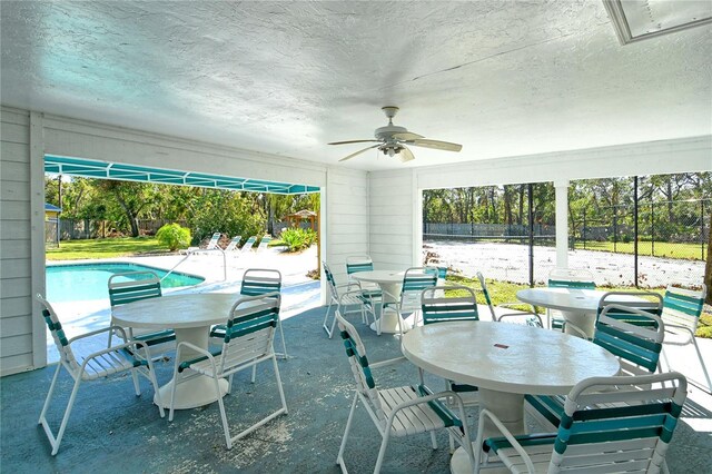 7806 Ontario Street Cir Unit 7806, Sarasota, FL 34243 - view of patio / terrace featuring outdoor dining area, a ceiling fan, and an outdoor pool