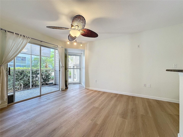 empty room with ceiling fan and light wood-type flooring