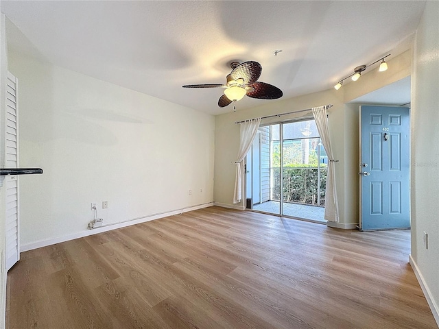 unfurnished room with ceiling fan and light hardwood / wood-style floors