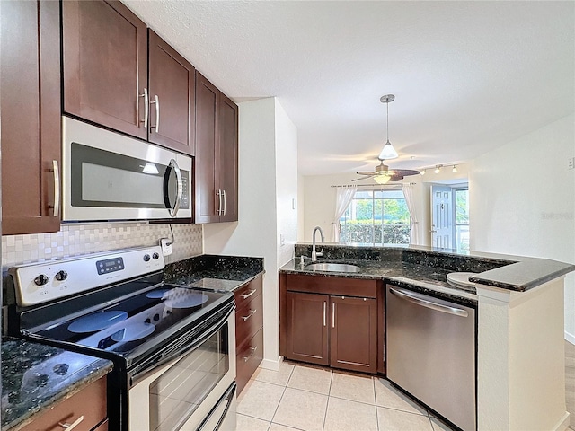 kitchen with backsplash, stainless steel appliances, ceiling fan, sink, and light tile patterned floors