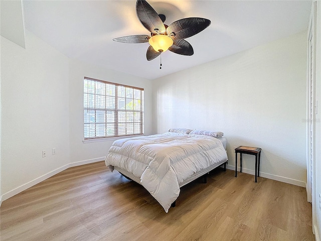 bedroom with light hardwood / wood-style flooring and ceiling fan