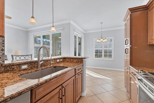 500 San Lino Cir Unit 511, Venice, FL 34292 - kitchen with a sink, stainless steel range, stone countertops, decorative light fixtures, and ornamental molding