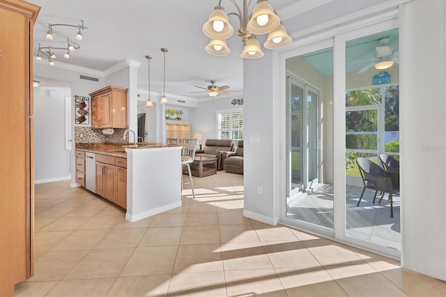500 San Lino Cir Unit 511, Venice, FL 34292 - kitchen featuring ceiling fan, crown molding, open floor plan, a chandelier, and backsplash