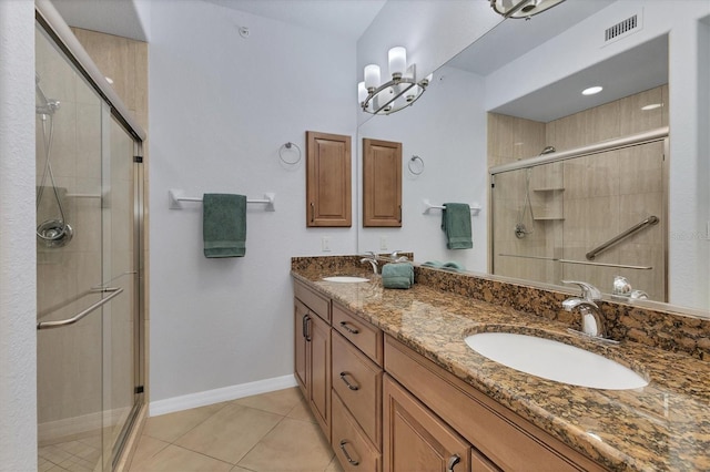 bathroom featuring vanity, tile patterned floors, and a shower with shower door