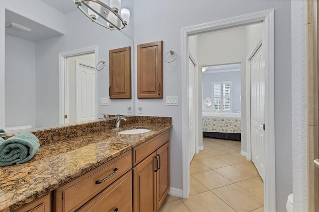 500 San Lino Cir Unit 511, Venice, FL 34292 - ensuite bathroom featuring vanity, tile patterned floors, baseboards, and toilet