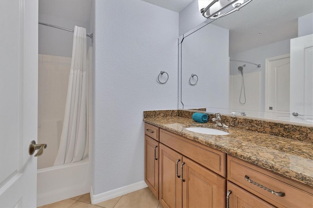 bathroom featuring tile patterned floors, vanity, shower / bath combination with curtain, and a textured ceiling