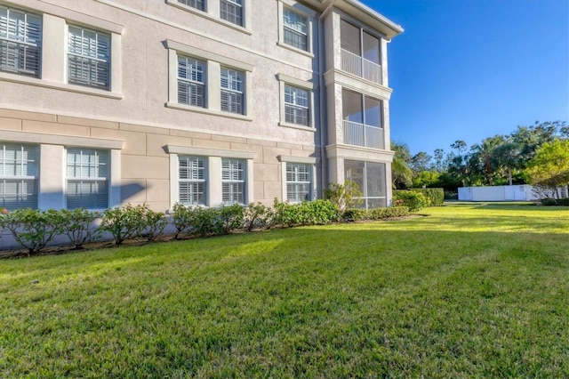 view of side of property with a yard