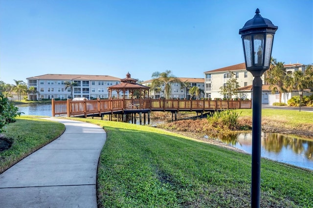 view of property's community featuring a gazebo, a yard, and a water view